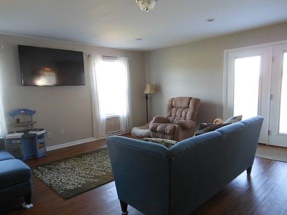Spacious 17x14 living room and living space extends out onto back deck.