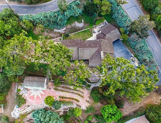 Overhead view showing home, barn and multiple pads and terraces. Secluded corner of Georgeff Rd (right) and Reata Ln (top).