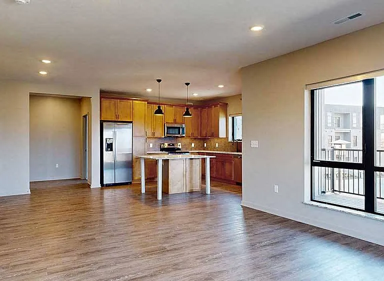 Gather and entertain in this spacious kitchen and dining area, featuring warm cabinetry and high-end finishes.