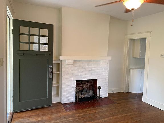 Living room. Hardwood floors throughout. Ceiling fans. Blinds.