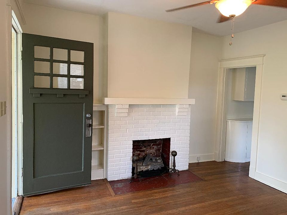 Living room. Hardwood floors throughout. Ceiling fans. Blinds.