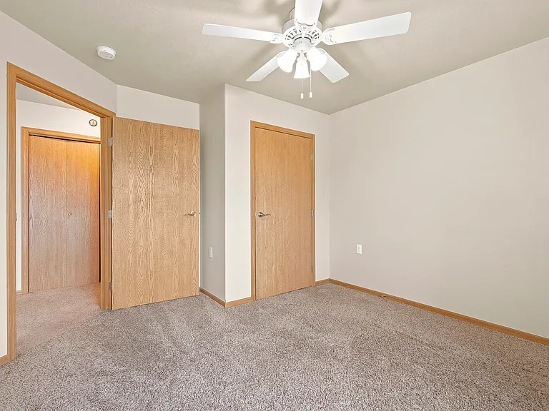 Step into a spacious haven at Northdale Apartments, featuring plush carpeting, ample closet space, and a bright ceiling fan for comfort. Ideal for your lifestyle, this cozy bedroom awaits your personal touch. Schedule a tour today!