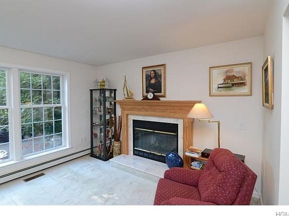Charming living room with wood burning fireplace.