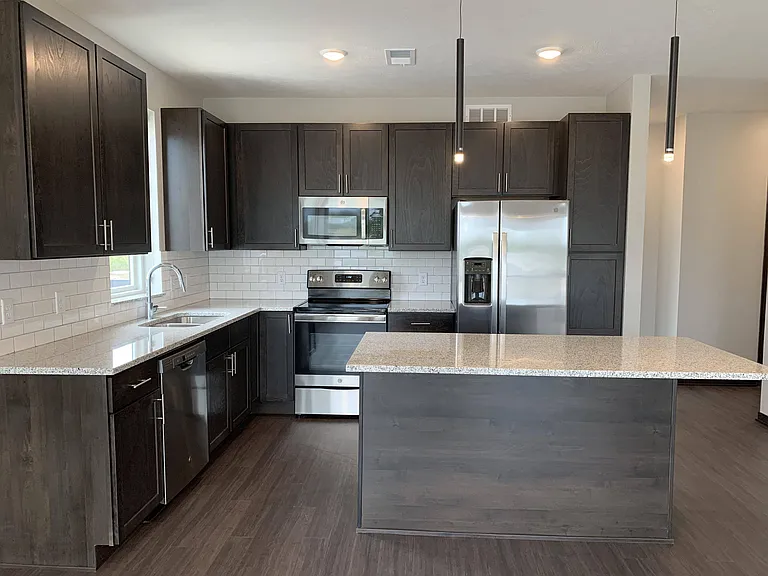 Our Dawn kitchens feature sleek cabinetry, stainless steel appliances, and spacious islands for modern living.