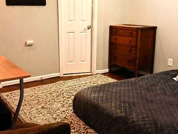 My assistant took this picture with her old phone. room is lovely and a decent size. This is a partial photo of a queen bed.