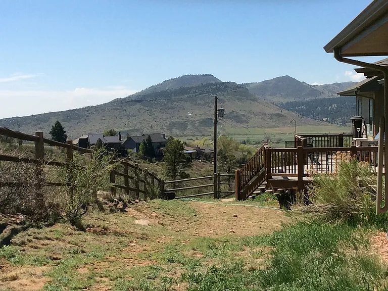 Fenced in yard on east side looking south.