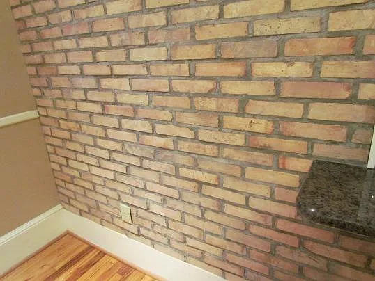 Antique Chicago brick wall between dining room and kitchen