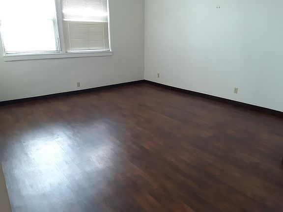 Large living room- lots of natural light- tall ceilings- hardwood vinyl plank flooring