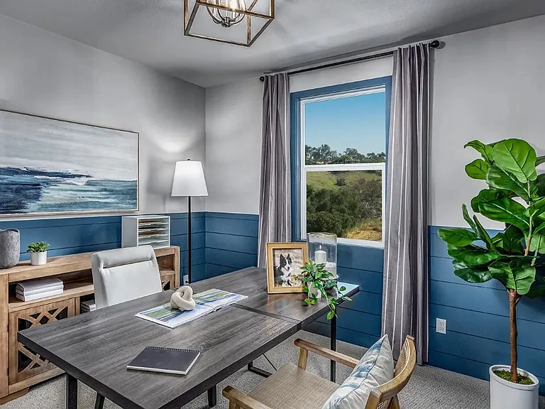 Room shown staged as a home office for scale _ delivered unfurnished. Spacious layout easily accommodates a bed, desk, and additional storage