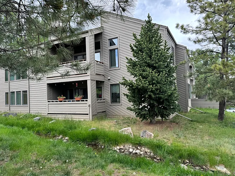 Rare Genesee Village condo surrounded by mature trees and the quiet beauty of the Colorado foothills.