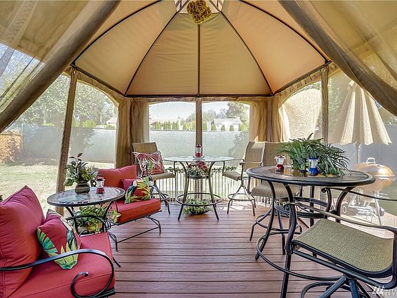 Trex style deck and covered gazebo that stays with the home.  Year-round yard enjoyment.