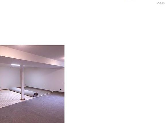 Lower level has a full bath and work shop with storage shelves!