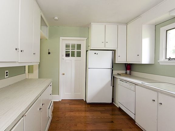 Kitchen with white cabinetry, light and bright.