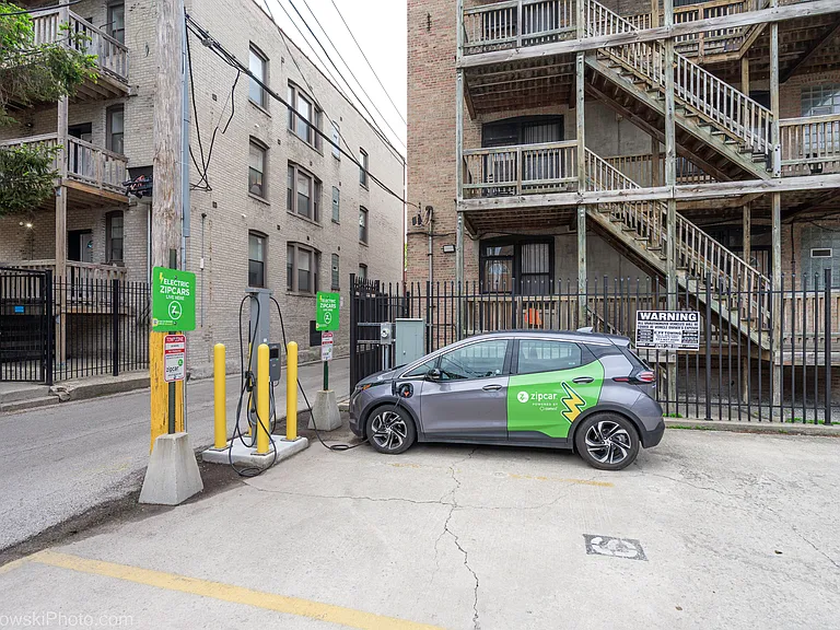 Zip cars are available for rent behind the building