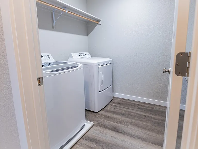 Upstairs laundry room comes equipped with a brand new washer and dryer.