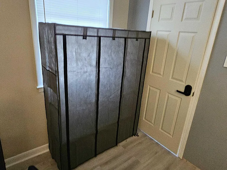 Private room with a window for natural light, durable flooring, and convenient access to a nearby closet/entry door.