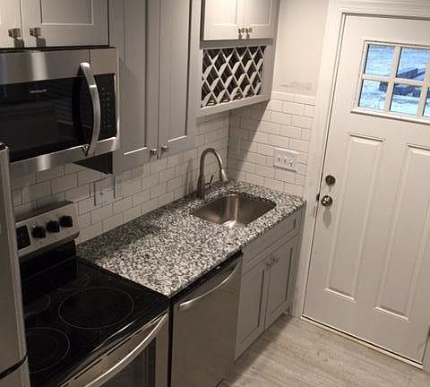 Kitchen with stainless steel appliances, granite, wine rack!