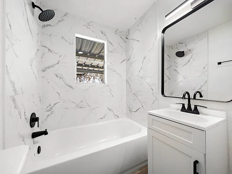 Shared hallway bathroom 1 with window.