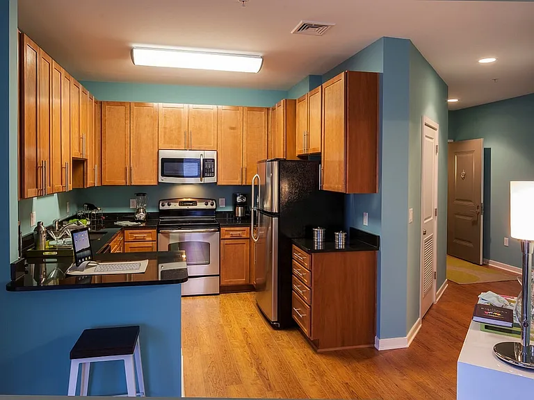 Contemporary Kitchen With Granite Countertops, Wood Cabinets & Stainless Steel Appliances