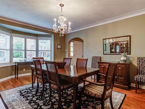 Attractive dining room with bay window, coved molding and wood floor for formal entertaining