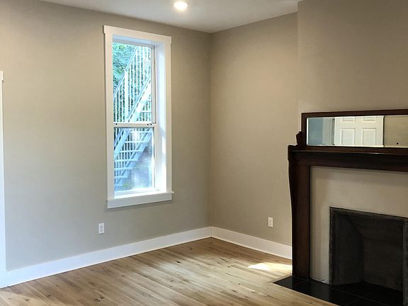 Large living room with restored antique mantle