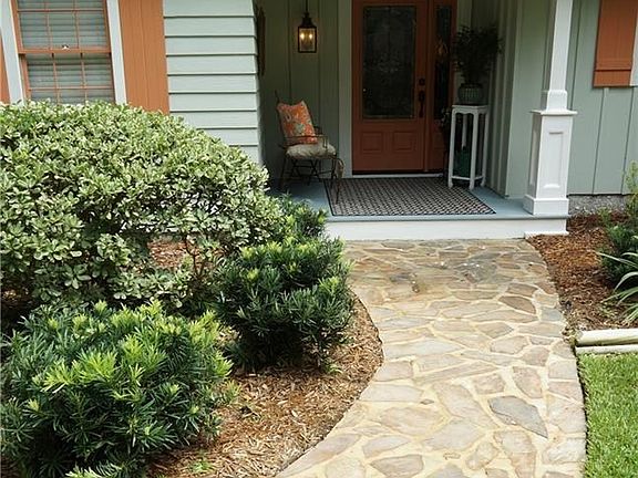 The custom masonry walkway embedded with a few seashells from a vacation in the Virgin Islands, a personal touch from the owners.