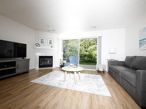 Living Room with Gas Fireplace, Leather Sofa and 50" Television