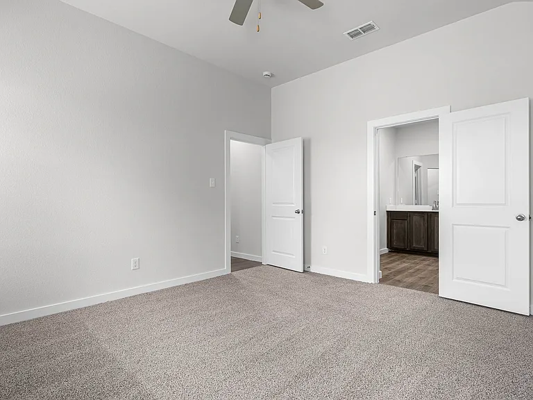 The master suite has a large bedroom, ensuite bathroom and a walk-in closet.