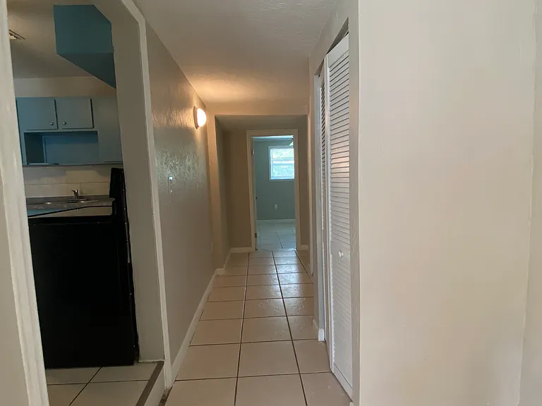 Hallway to rear area. Rear area has 3 bedrooms, laundry room with a door to backyard