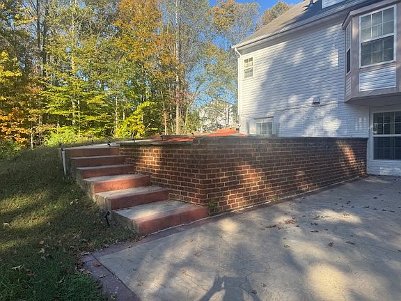 Stairs from parking spaces to stamped patio