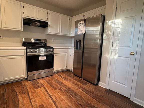 Kitchen with new appliances including new stove and fridge. Also new dishwasher