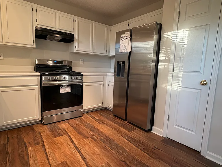 Kitchen with new appliances including new stove and fridge. Also new dishwasher