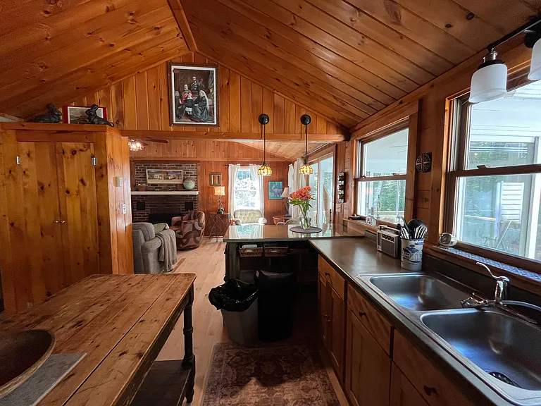Kitchen with new stove, all modern appliances, coffee maker, and antique farm table.