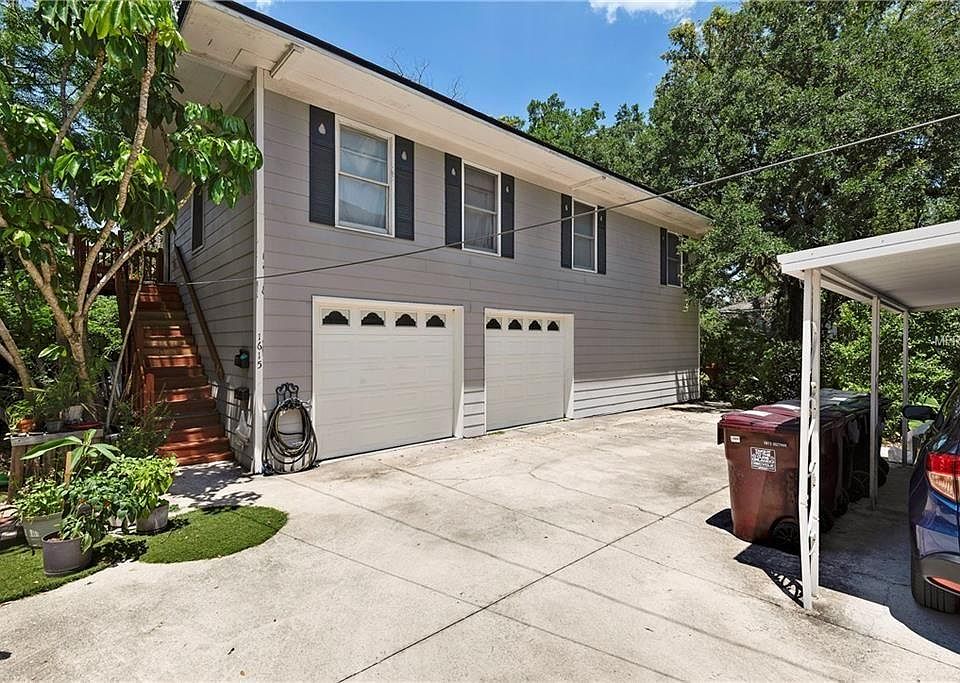 Two car garage with two separate and private apartments. Apartment B 1/1 First floor Right side French door entrance facing rainforest like landscaping. Left side garage parking With left side entrance with arbor.