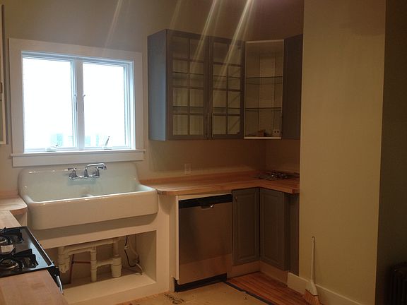 Antique farm sink with new dishwasher. Note: Some cabinet do