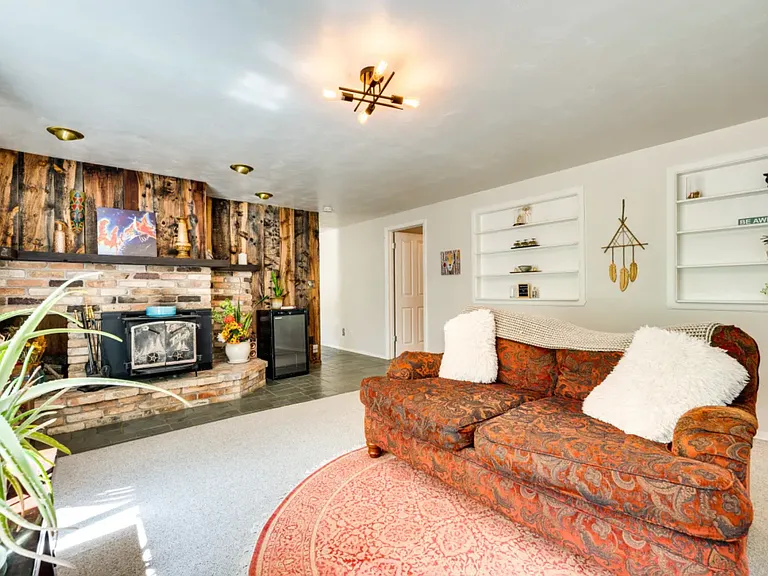 2nd living room Garden level with rustic wood burning stove.