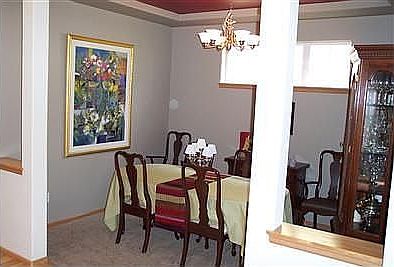 Formal dining room off kitchen with coved ceiling.