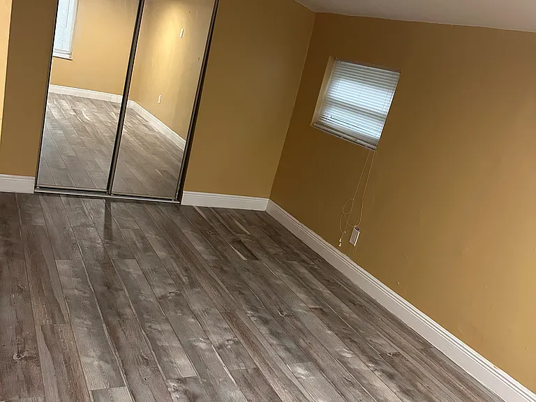 Comfortable rear bedroom with a generous sliding-door closet offering plenty of storage space.