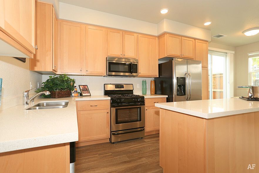 Spacious modern kitchen with island in our 2, 3 & 4 bedroom townhomes