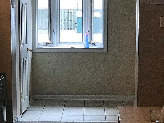 Open foyer with lots of light and 1/2 BA.