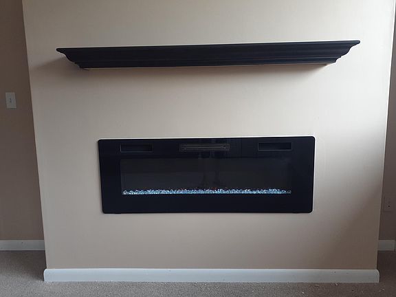 Ebony Poplar wood mantle and 7,000BTU electric fireplace with 15 different settings, timer, and remote
