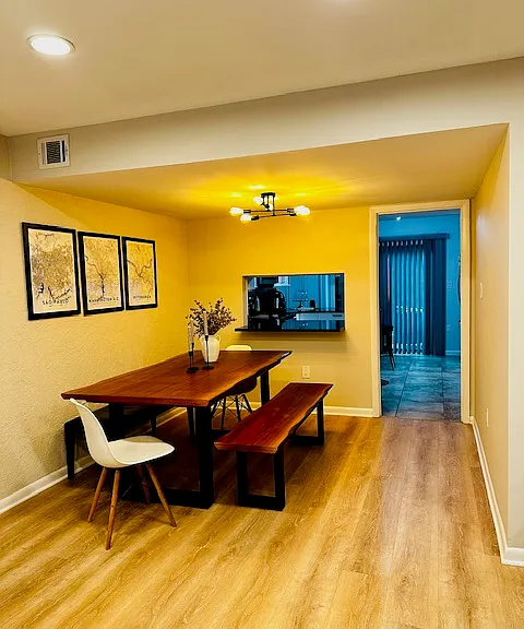 The dining room offers a warm and welcoming space, perfectly positioned to flow seamlessly into the open-concept living room. Ideal for both intimate dinners and larger gatherings, this airy layout encourages connection and conversation.