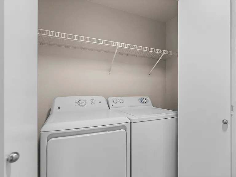 Enjoy the convenience of a full-size washer and dryer with additional shelving for laundry and household storage. Enjoy the convenience of a full-size washer and dryer with additional shelving for laundry and household storage.