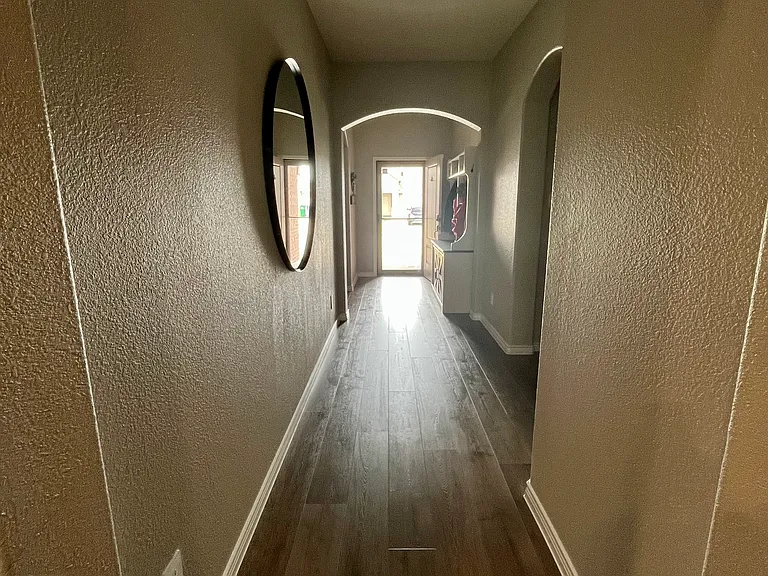 Hall way to front door, garage, laundry room, full bathroom and all three standard bed rooms