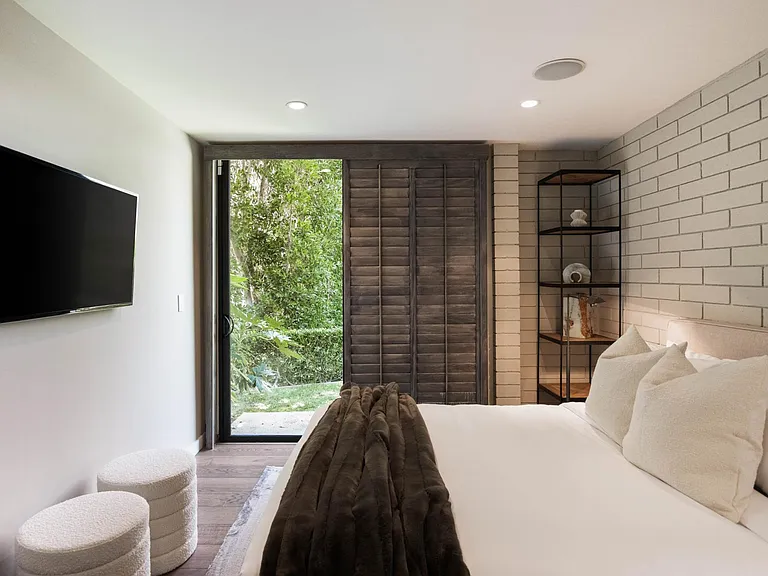 The bedroom sets the scene for relaxation with seamless access to the outdoor space.