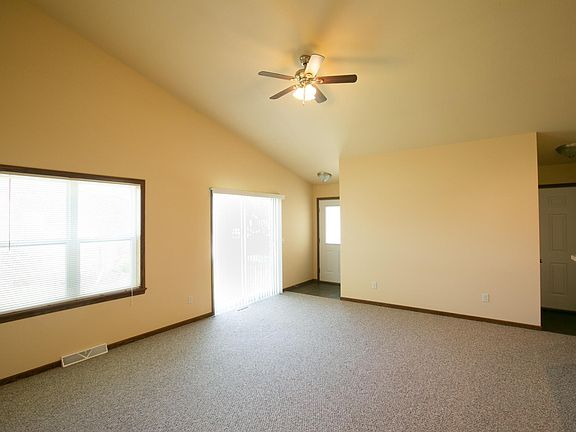 Vaulted ceiling spacious living room with patio doors.