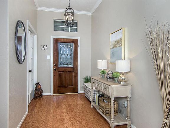 A leaded glass door and transom light above the front door let light filter into this stunning Entry. A recently updated Pendant Light and wood flooring are featured here.