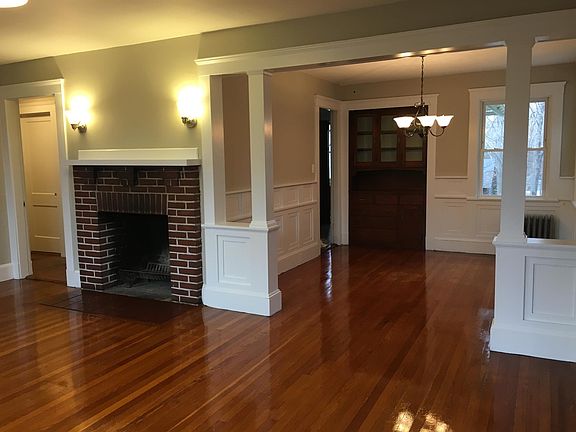 Living room with fireplace, looking into dining room