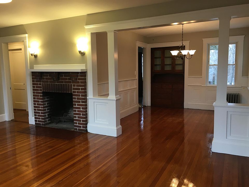 Living room with fireplace, looking into dining room