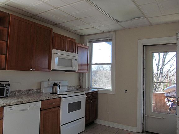 Kitchen features cherry cabinets and access to the deck